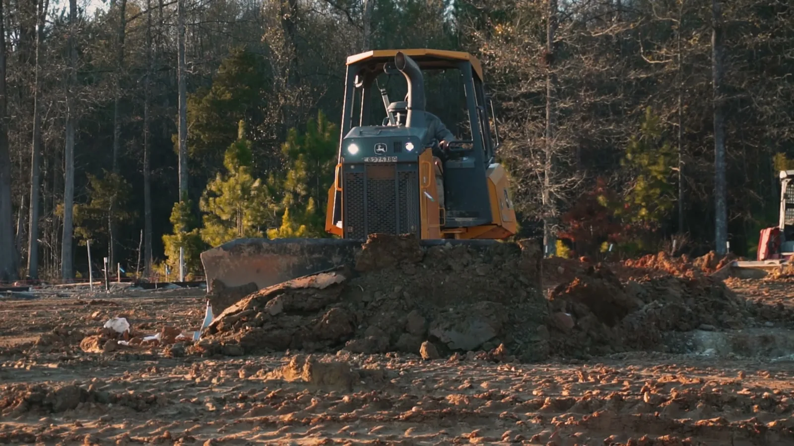 Dozer clearing a wooded site for a new commercial building, commercial general contractor