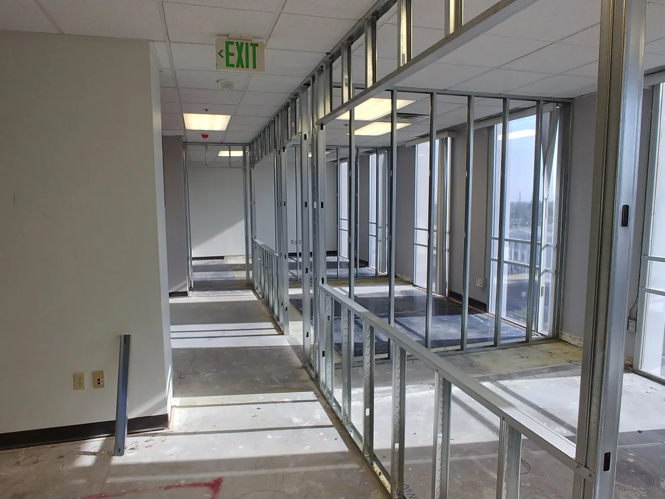 New metal stud partition walls framed across an emptied office floor, commercial upfits