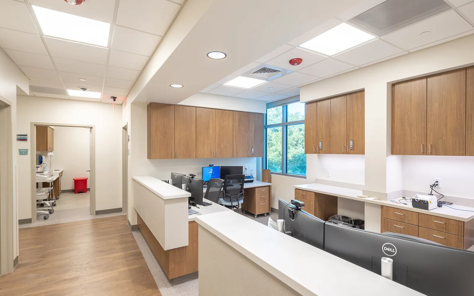 Newly finished medical office nurse station with wood casework and computer workstations, medical office build outs
