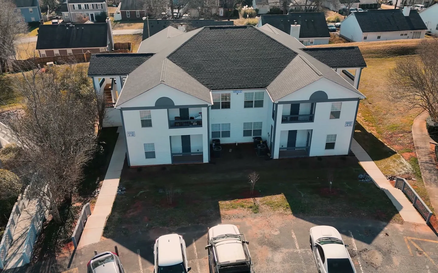 Aerial view of a two story multi family building with its parking lot, multi family construction