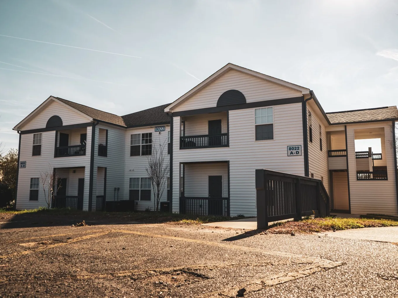 Two story multi family building with stacked balconies and new landscaping, multi family construction