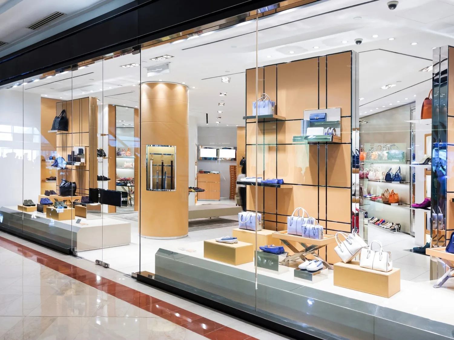 Finished glass storefront of a shoe and handbag store with wood display walls, retail build outs